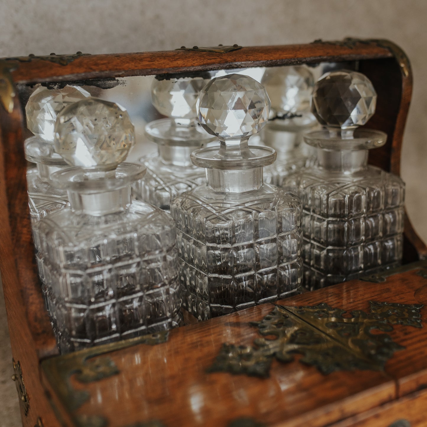 Antique Oak and Brass Inlaid Tantalus with Three Cut Crystal Decanters & Secret Game Drawer